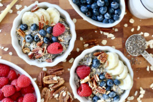 chai seed oatmeal bowls with berries chia seeds and pecans