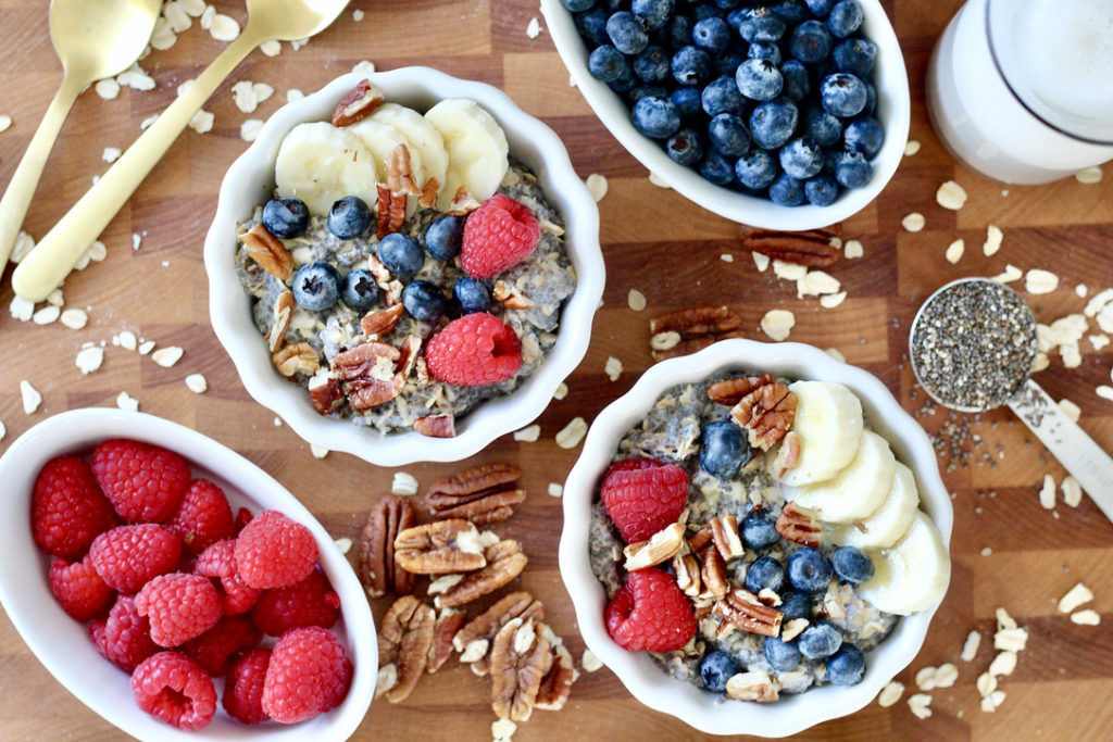 chai seed oatmeal bowls with oatmeal toppings and almond milk