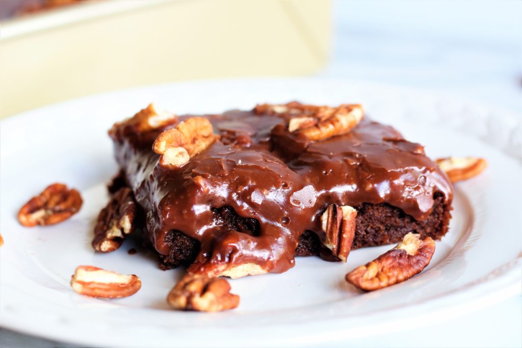 gluten ree chocolate cake with icing and pecans