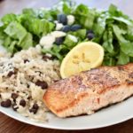 pan fried salmon with rice and salad on white plate how to cook salmon