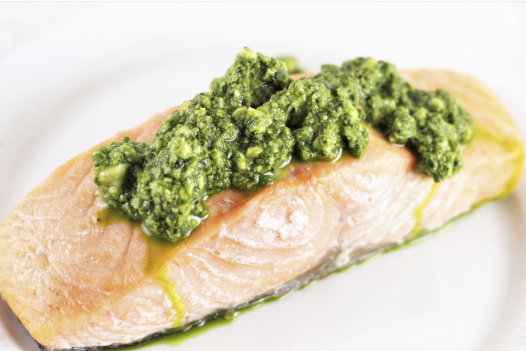 how to cook salmon on white plate with pesto sauce