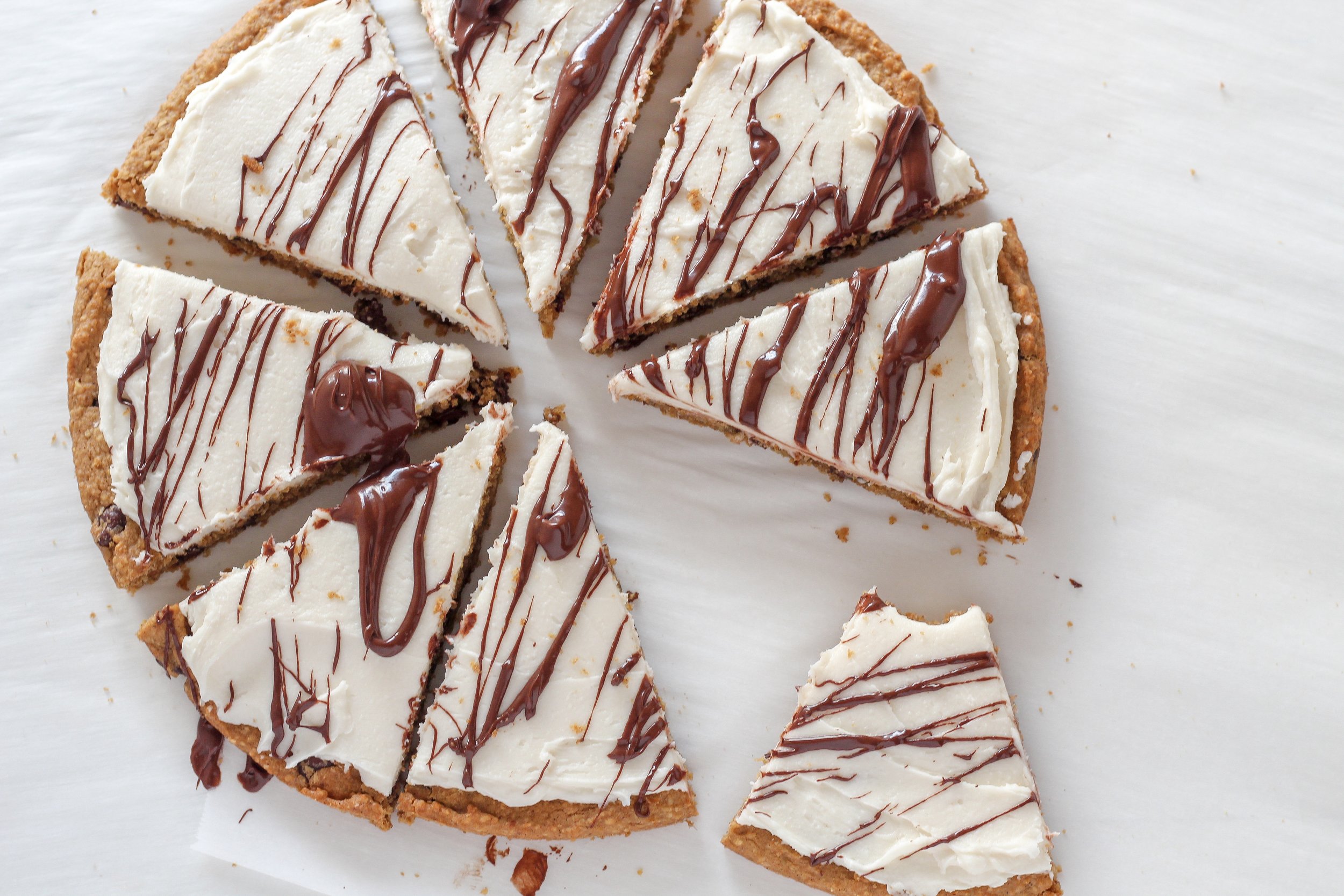 Low Sugar Gluten Free Chocolate Chip Cookie Cake | Milk & Honey Nutrition aerial view of slices of Low Sugar Gluten Free Chocolate Chip Cookie Cake