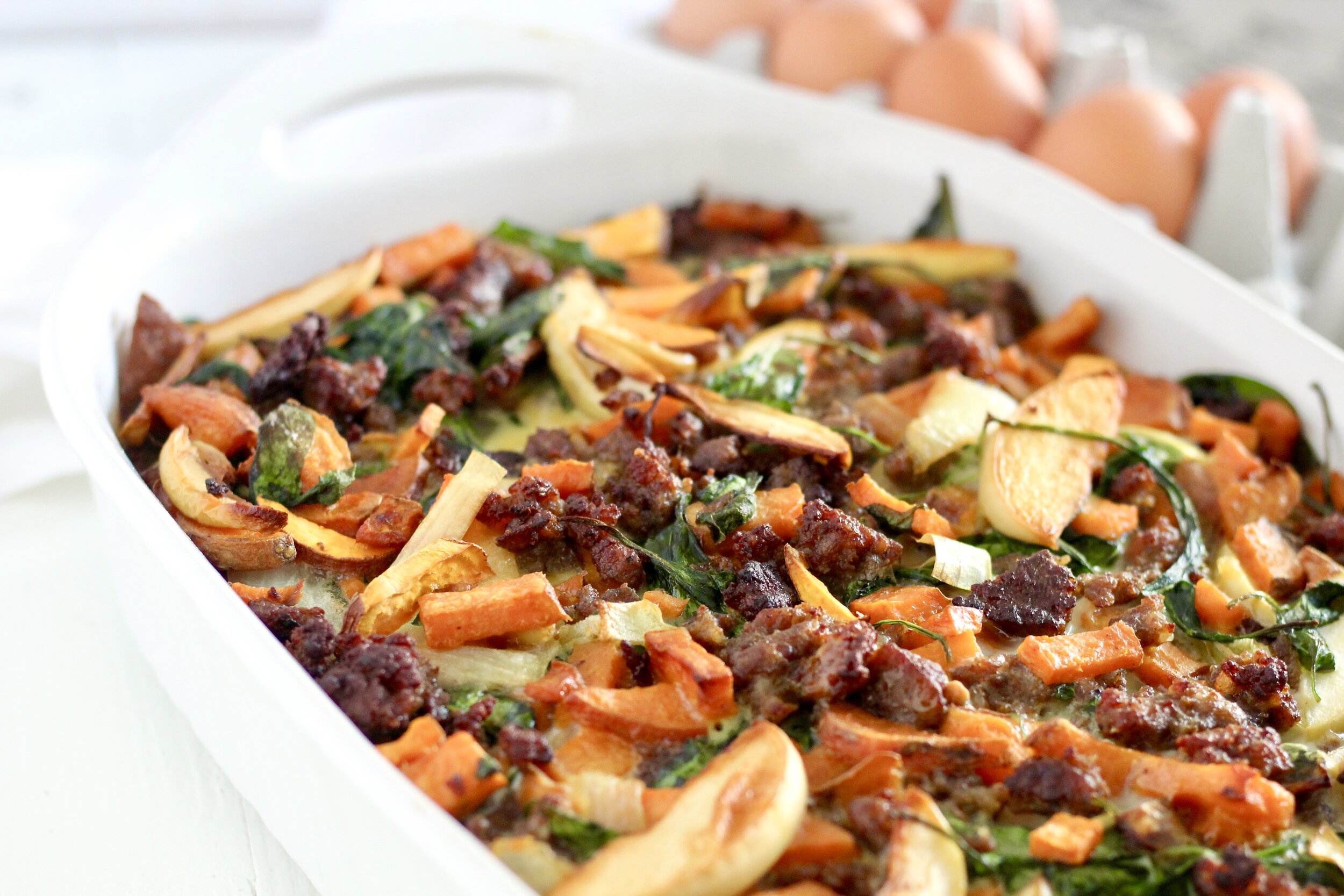 Caramelized Onion, Apple, and Sweet Potato Overnight Breakfast Bake | Milk & Honey Nutrition Caramelized Onion, Apple, and Sweet Potato Overnight Breakfast Bake in a white pan