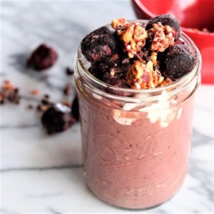 Cherry Superfood Smoothie topped with cherries in a mason jar