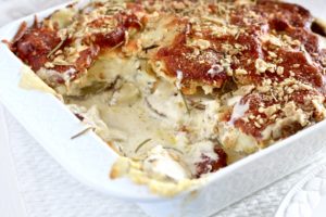 Friendsgiving Gluten Free Cheesy Au Gratin Potatoes with slice missing