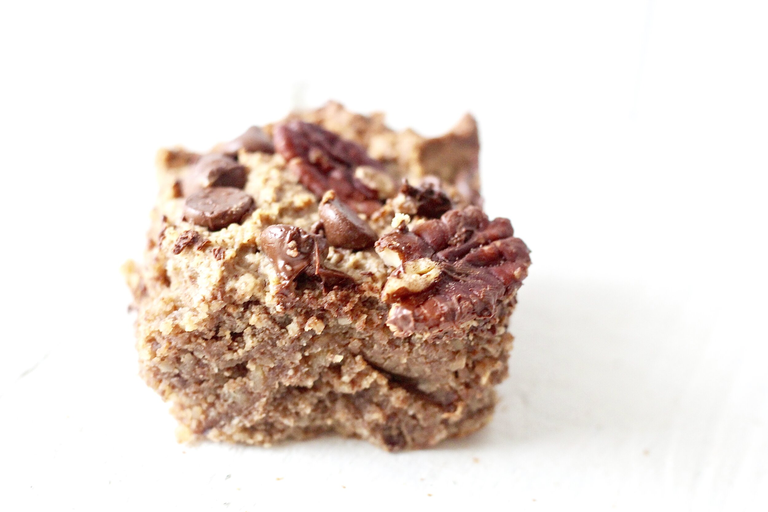 grain free coconut pecan chocolate chip cookie bar with white background