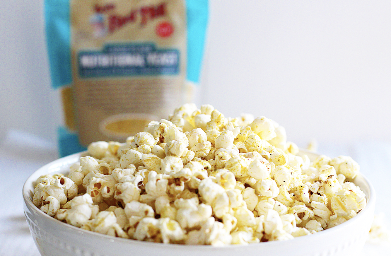 Homemade Zesty Ranch Popcorn Perfect for Movie Night | Milk & Honey Nutrition Homemade Zesty Ranch Popcorn Perfect for Movie Night with bag of bobs red mill nutritional yeast