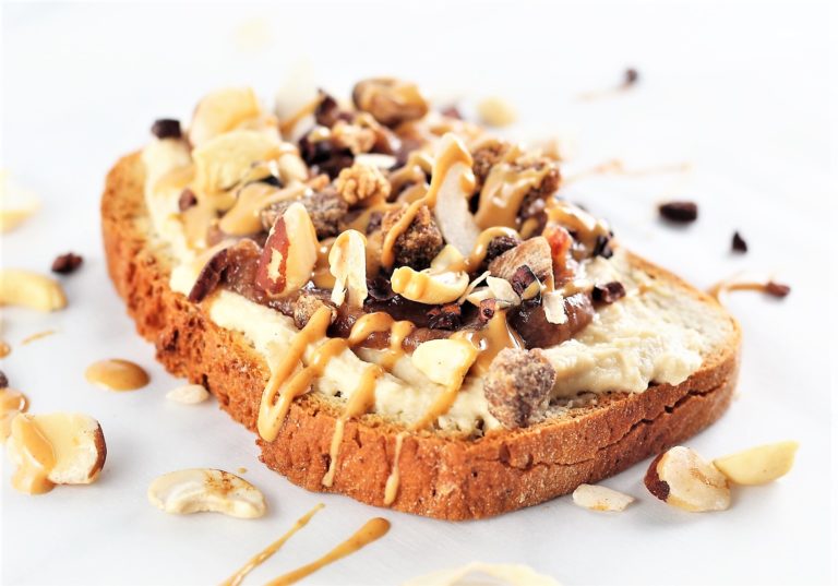 toast topped with hummus, dates, and drizzled with nut butter