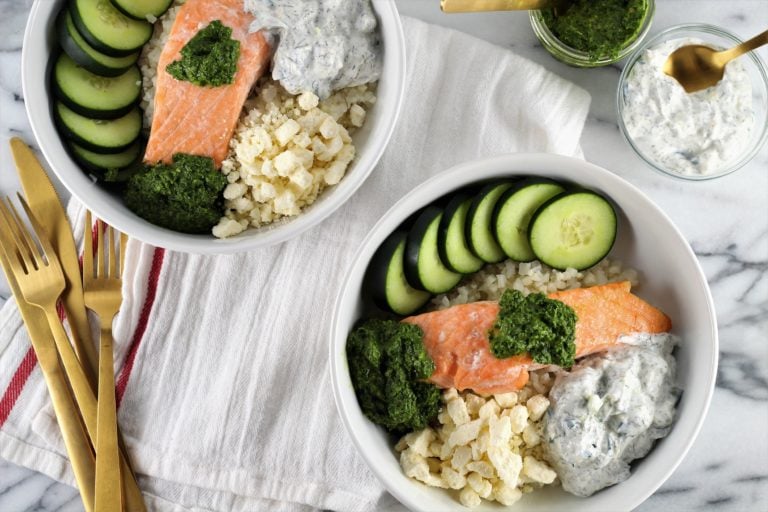 Mediterranean Cauliflower Rice Bowls with Norwegian Salmon | Milk & Honey Nutrition aerial view of Mediterranean Cauliflower Rice Bowls with Norwegian Salmon