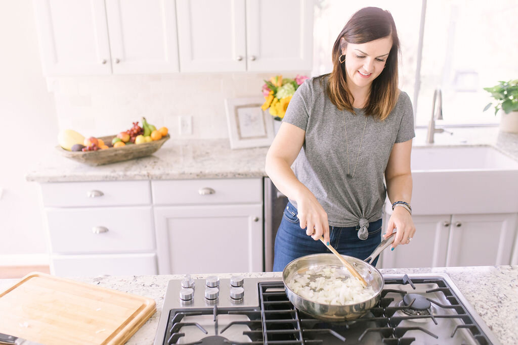 Mary Ellen Phipps cooking onions in pan