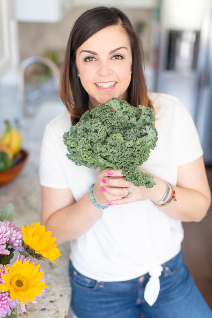 Mary Ellen Phipps holding a bunch of kale