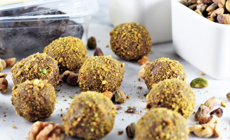 No-Bake Pistachio Walnut Energy Balls on counter with bowl of pistachios