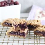 Paleo Blueberry Breakfast Bars on cooling rack with bowl of blueberries and bob's red mill mix