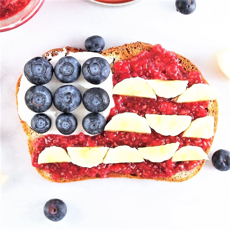 Toast designed in american flag with blueberries, banana, and raspberries