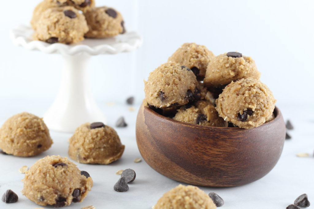 cookie dough balls in bowl, on platter, and on table