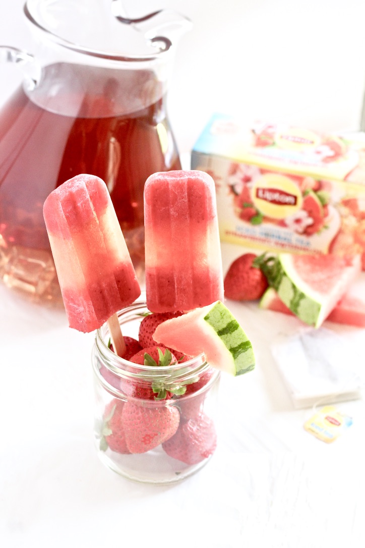 Strawberry Watermelon Iced Tea Pops | Milk & Honey Nutrition Strawberry Watermelon Iced Tea Pops with pitcher of tea in background
