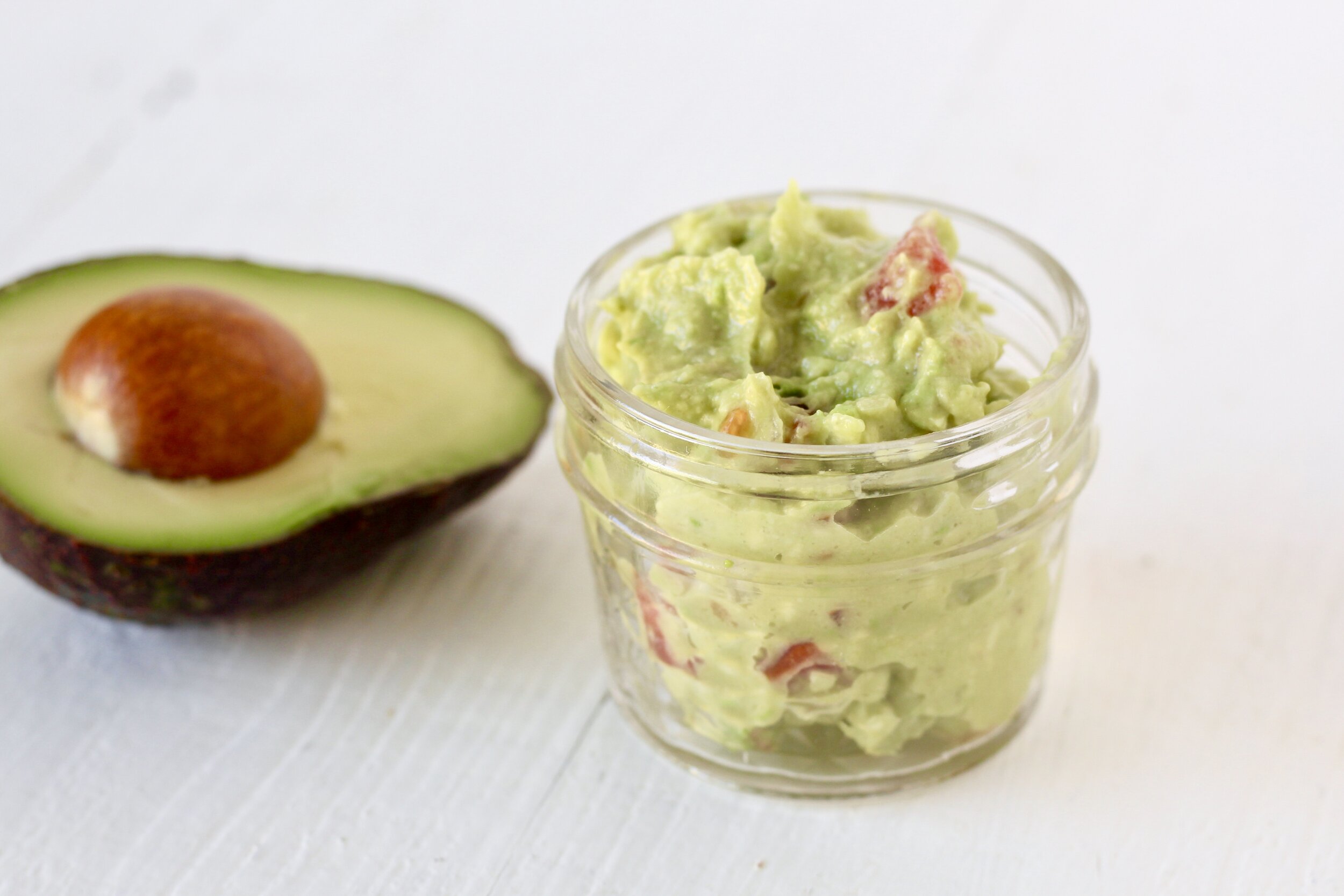 5 minute guacamole for one | Milk & Honey Nutrition small jar of guacamole for one with half of an avocado