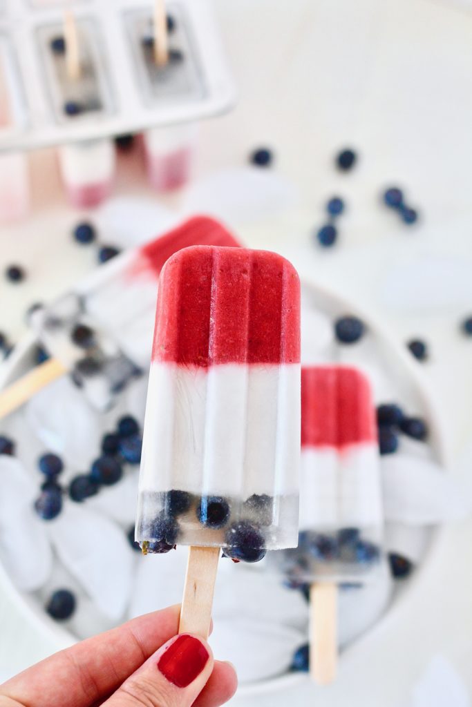 red white and blue fruit popsicles in bowl of ice