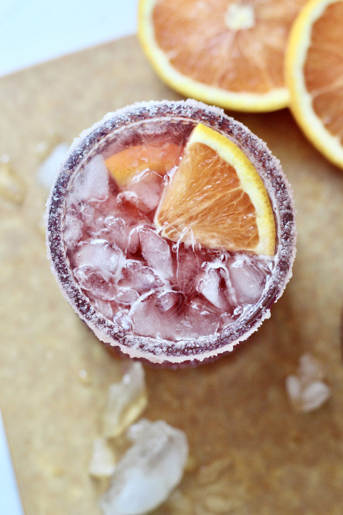 pomegranate martini with orange wedge