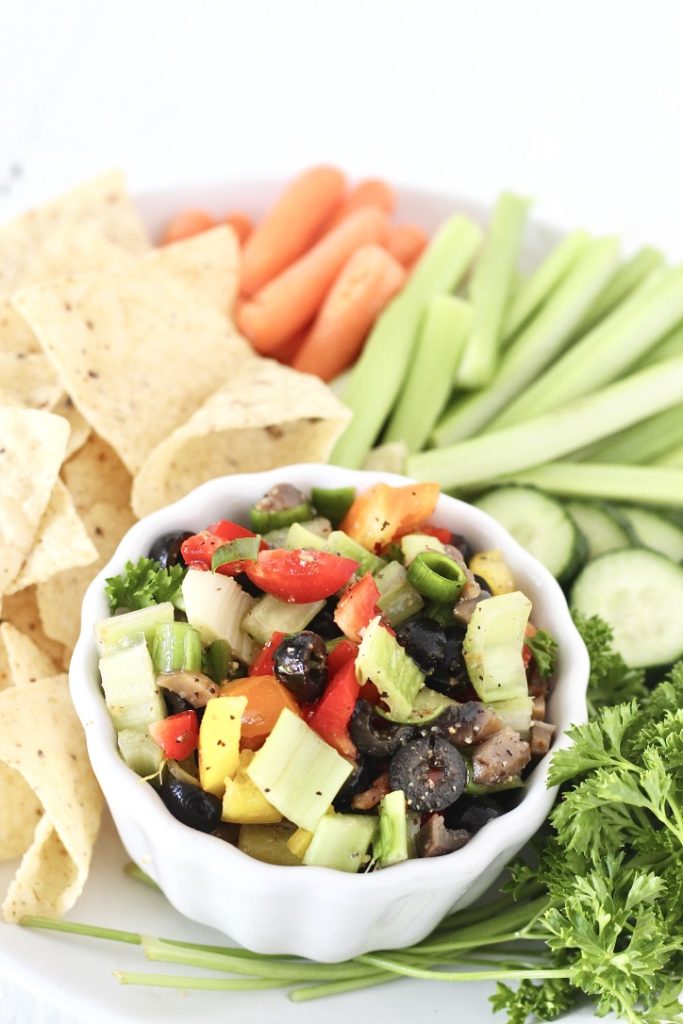 veggie dip in a bowl with chips and vegetables