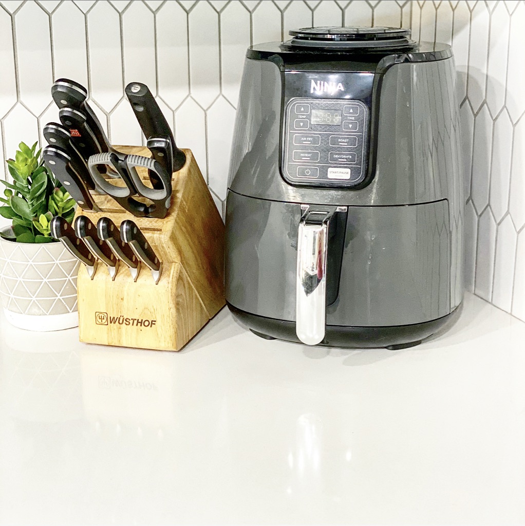 how to use an air fryer | Milk & Honey Nutrition knife block with an air fryer on white quartz countertop