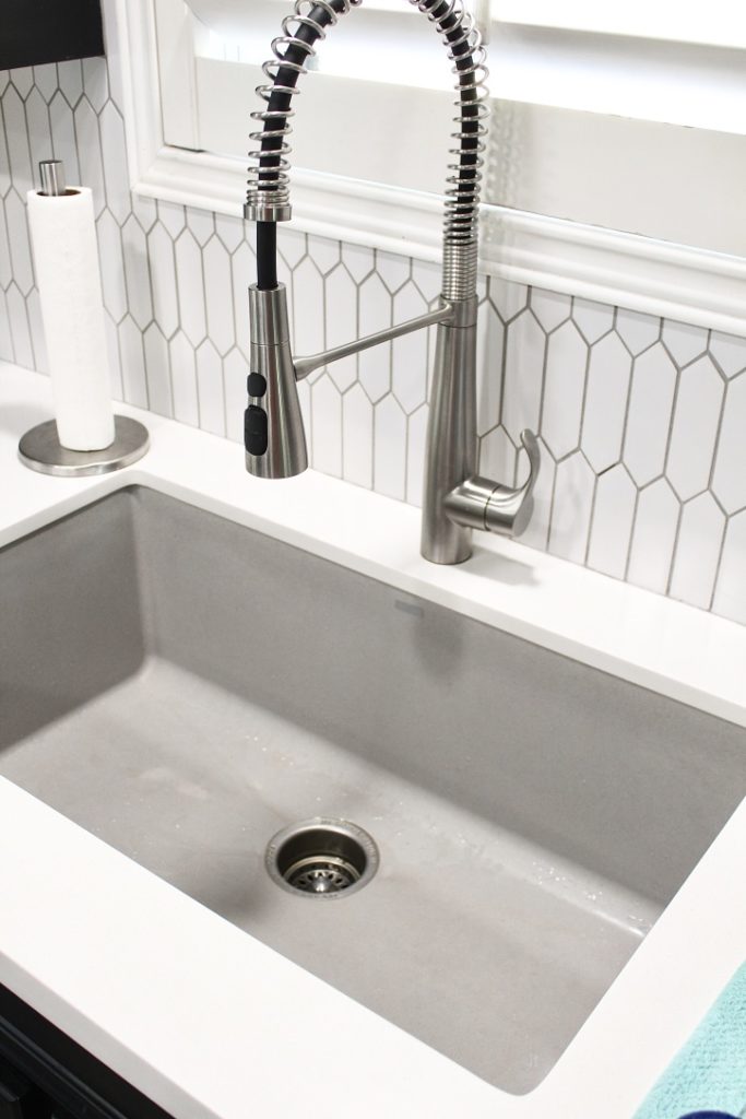 clean granite sink with industrial faucet