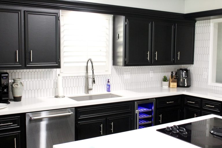 clean kitchen with black cabinets and white countertops