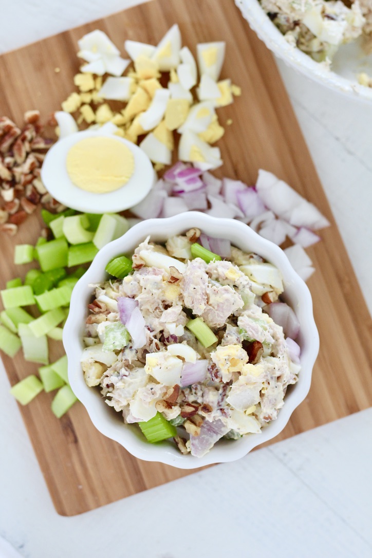 tuna salad on cutting board with hard boiled egg onion and celery