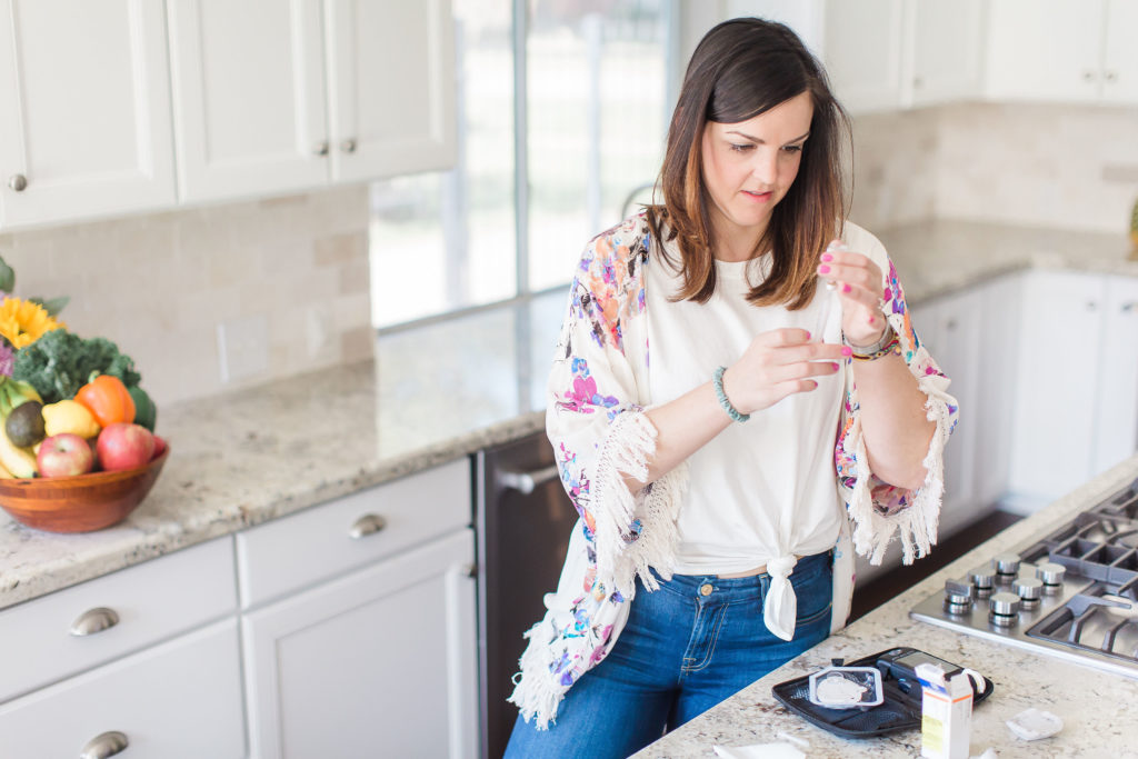 woman managing diabetes in white kitchen