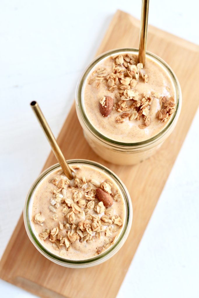 two sweet potato smoothies in mason jars with gold metal straws