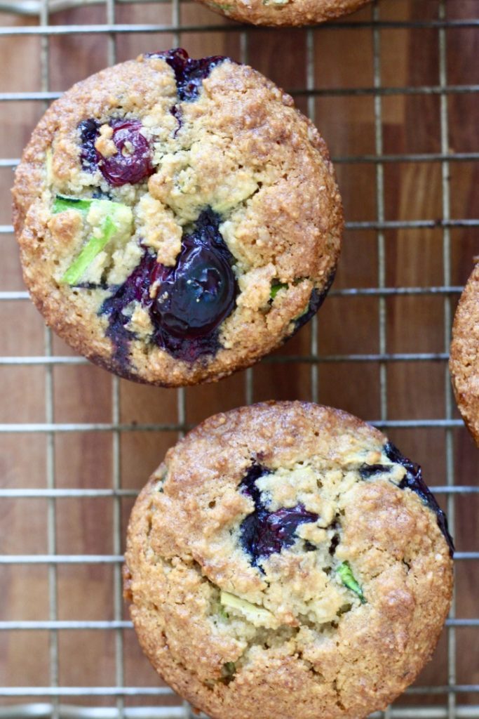 blueberry zucchini muffins on baking rack