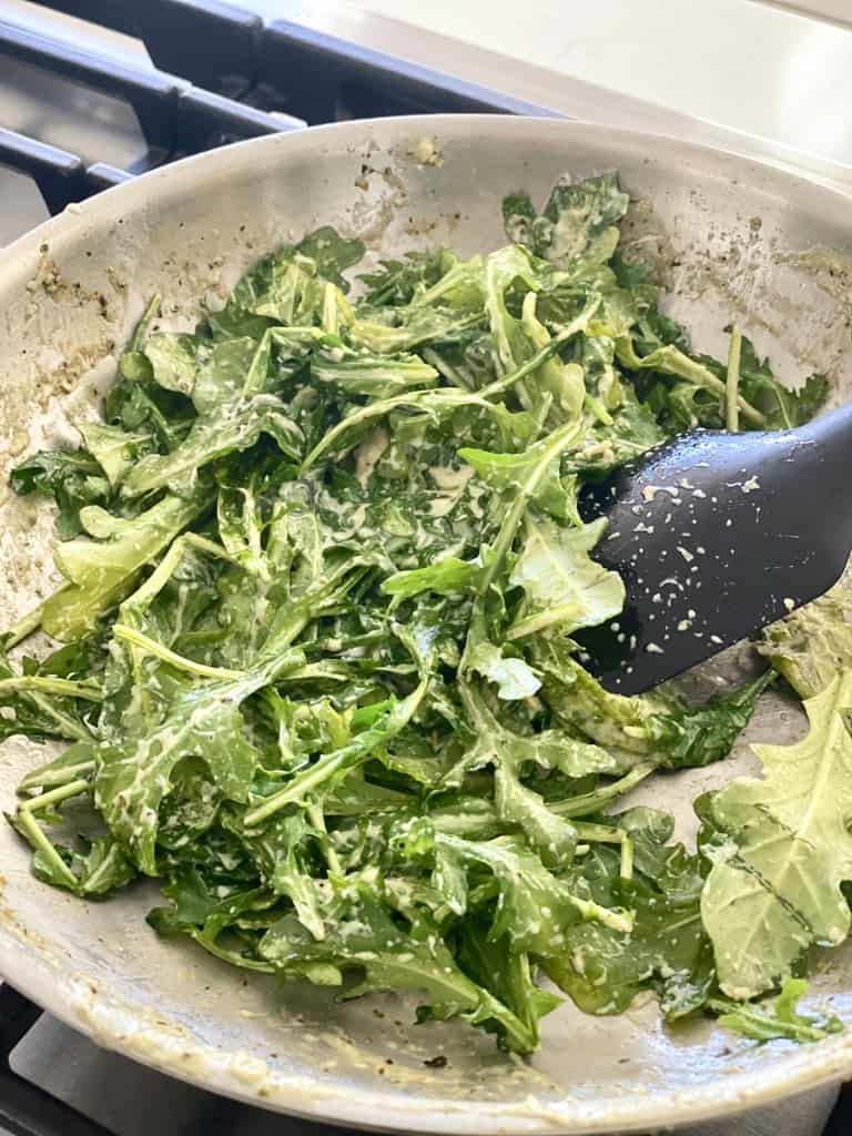 arugula in stainless steel pan artichoke pesto pasta