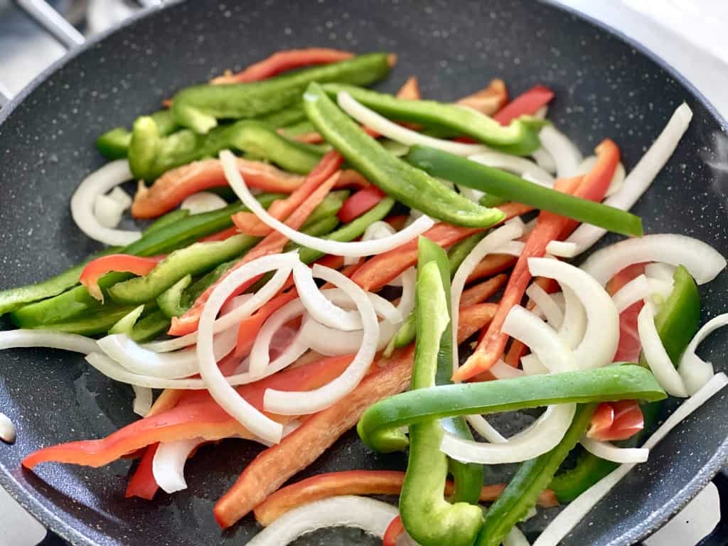 bell peppers and onion in pan for chicken fajita casserole