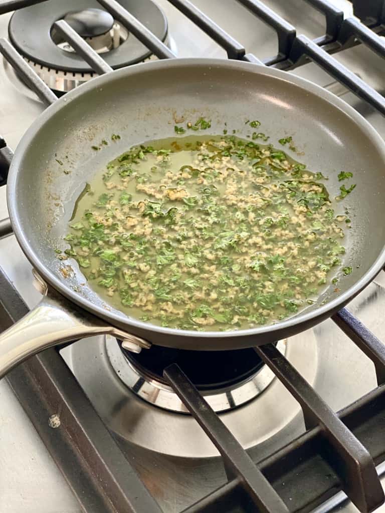 garlic and parsley in pan on stovetop gluten free garlic knots