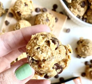 hand with green nail polish holding oatmeal protein balls is oatmeal good for diabetes?