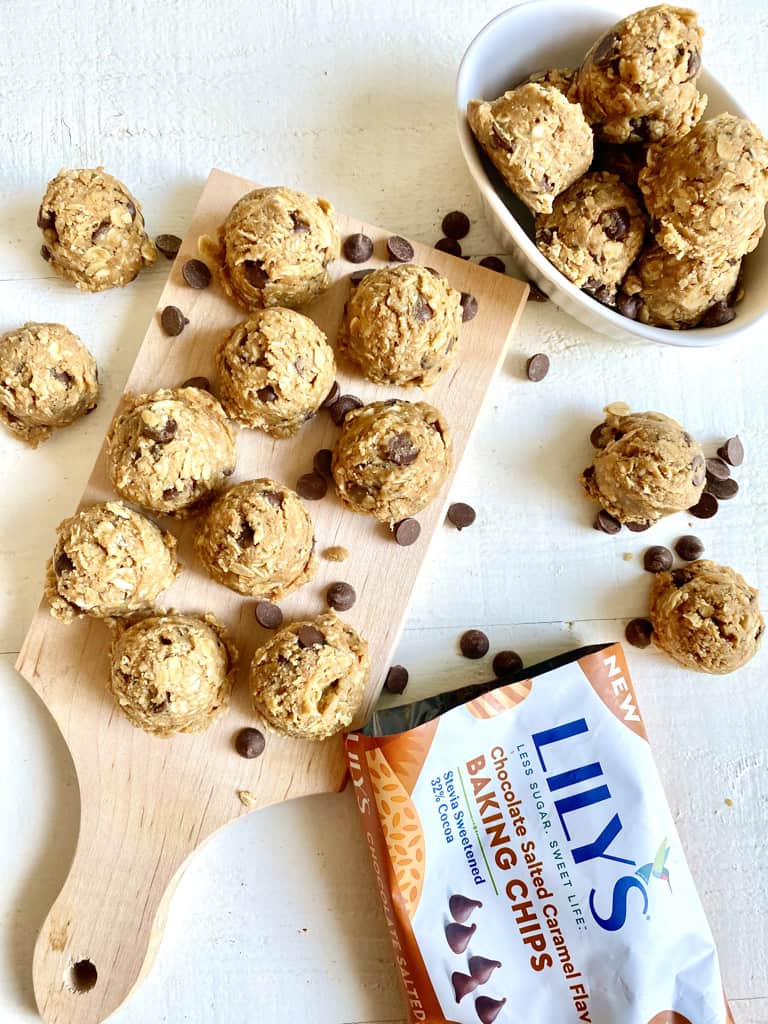 oatmeal protein balls with chocolate chips on wood board with lilys chocolate chips