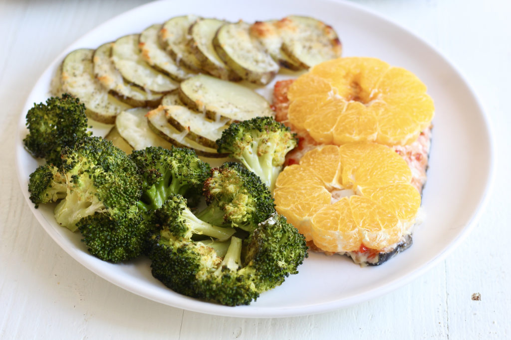 dinner plate with salmon broccoli citrus and potatoes from one pan salmon and veggies