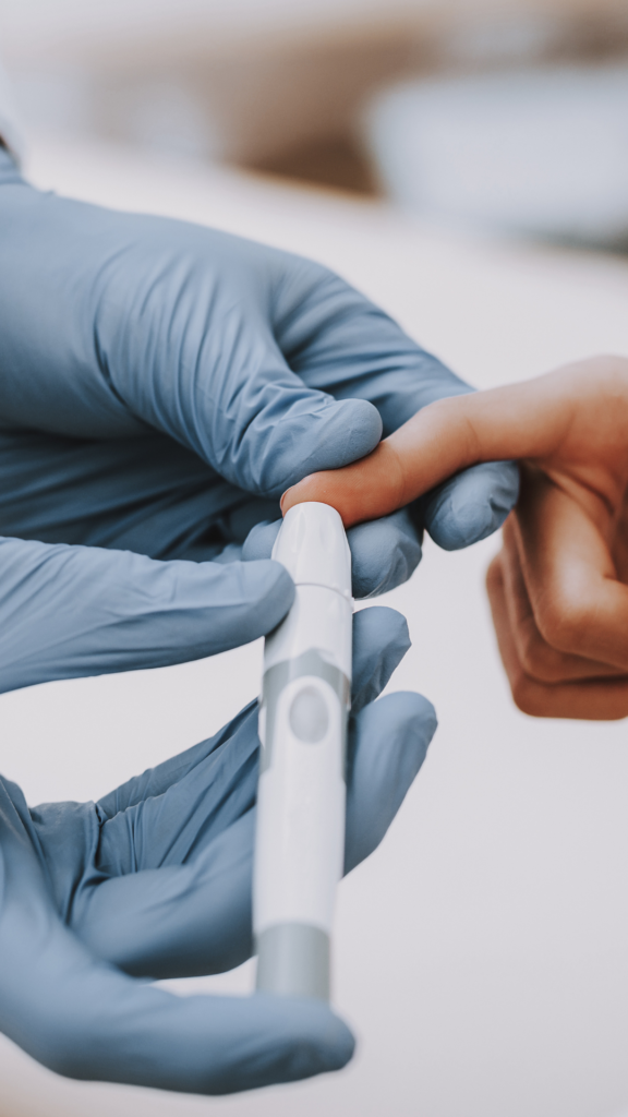 how to lower a1c naturally finger prick | Milk & Honey Nutrition finger being pricked for testing a1c