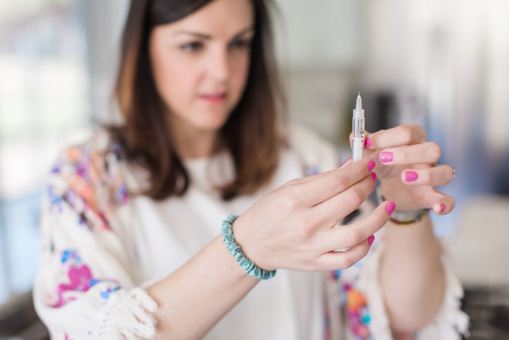 woman tapping insulin syringe types of insulin new treatments for diabetes
