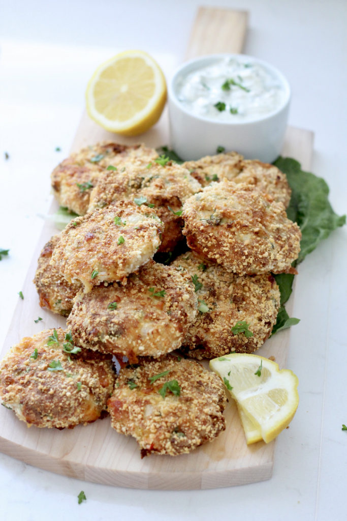 salmon patties from air fryer on wood paddle with aioli sauce