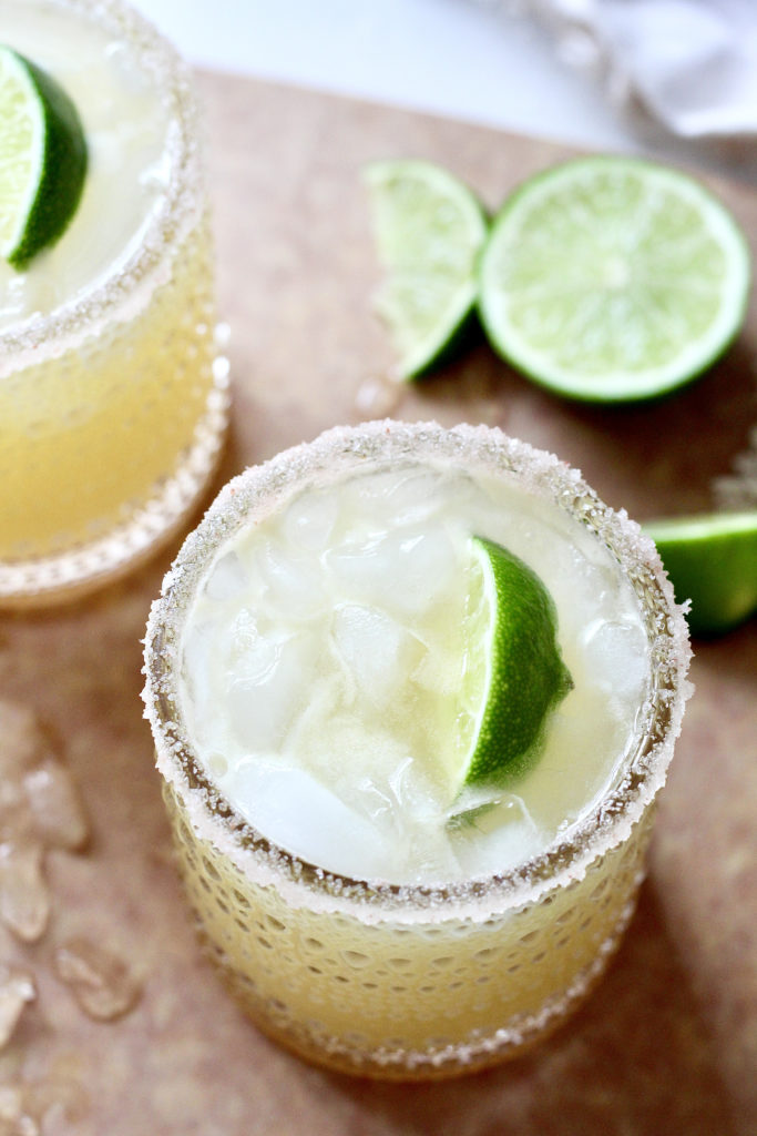 flat lay of skinny margarita with limes