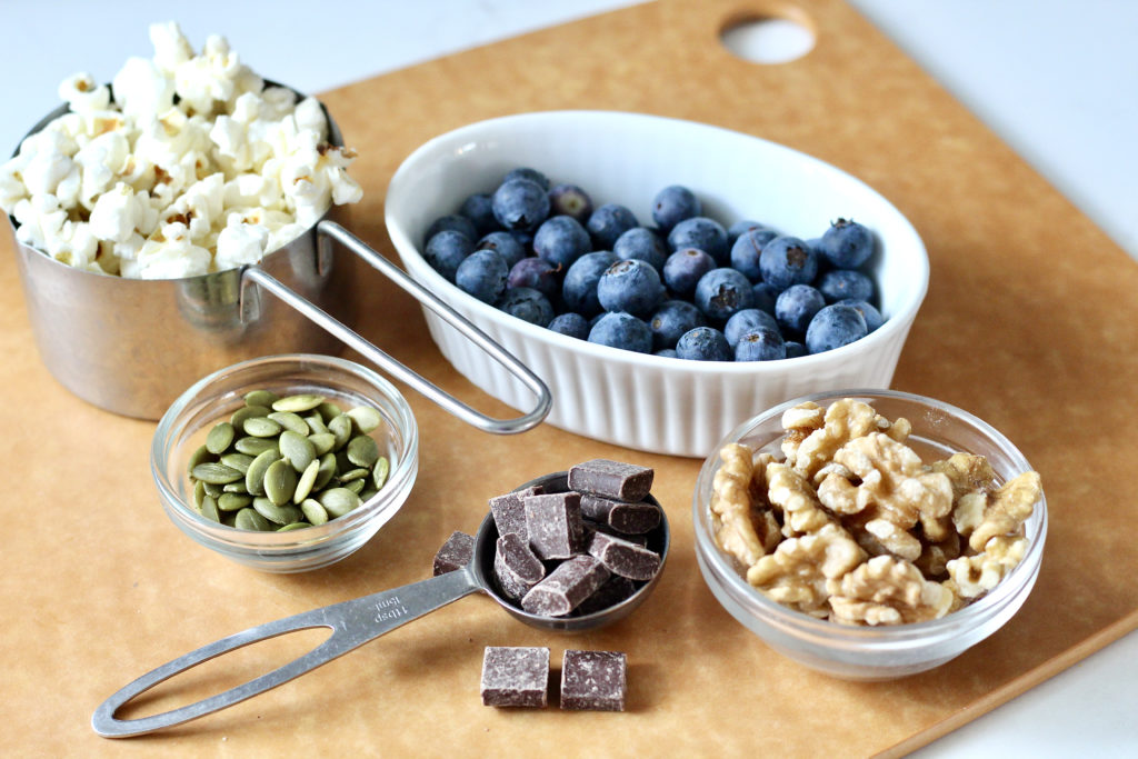 homemade trail mix  ingredients popcorn walnut blueberries pumpkin seeds chocolate