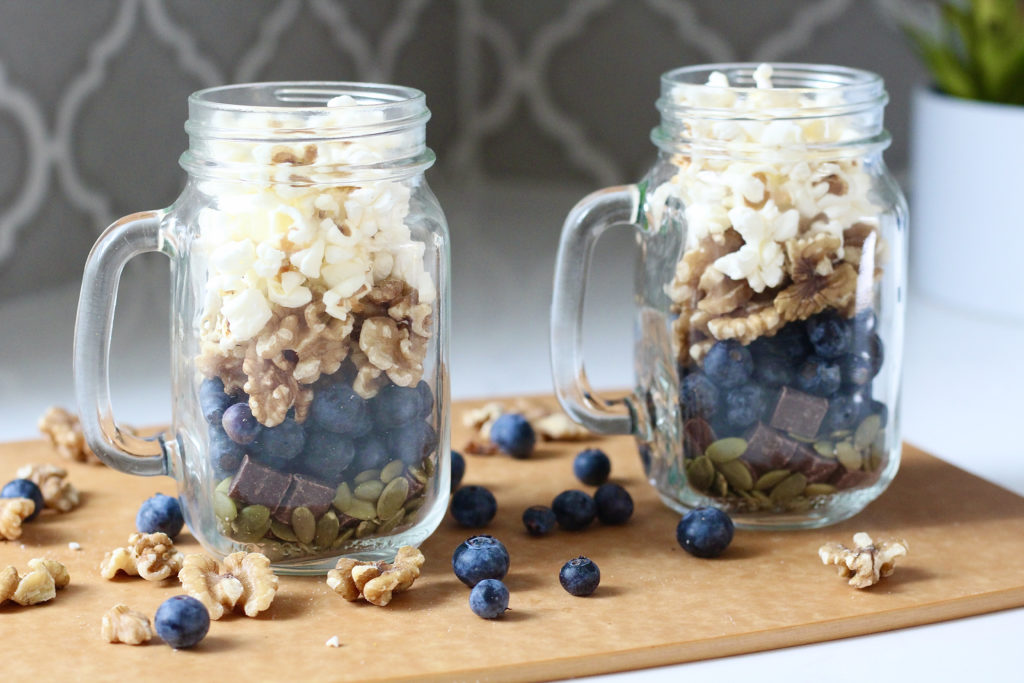 homemade trail mix with blueberries and walnuts in mason jars