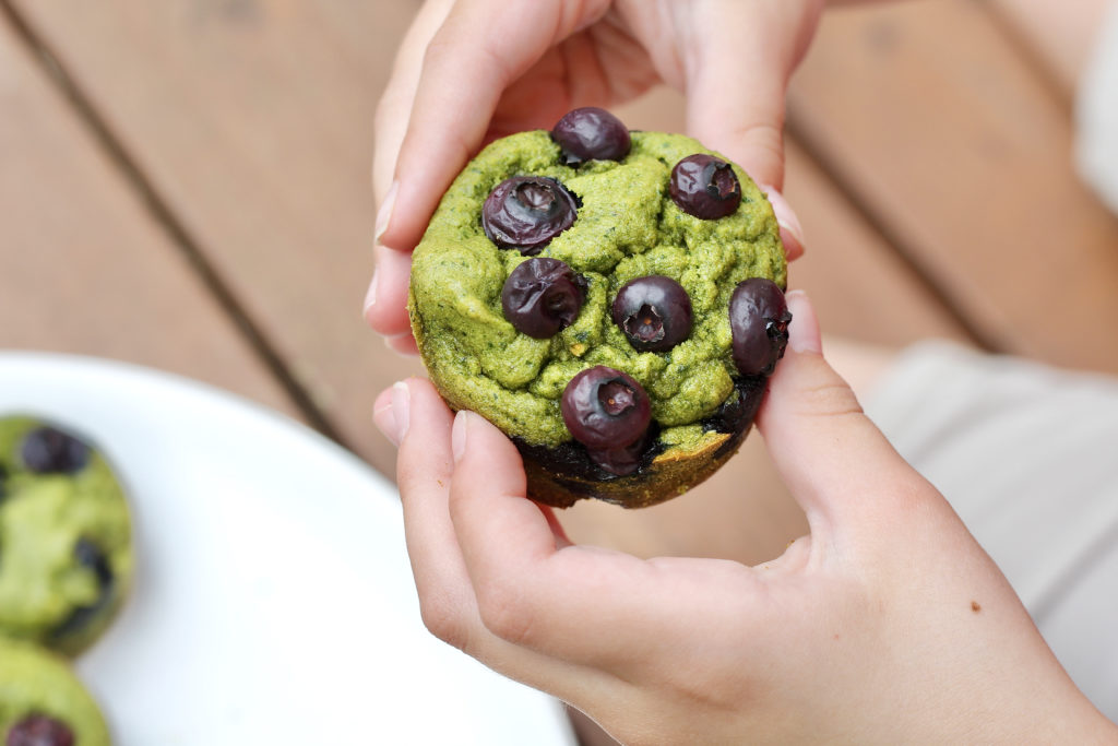 kids hands holding spinach blender muffins