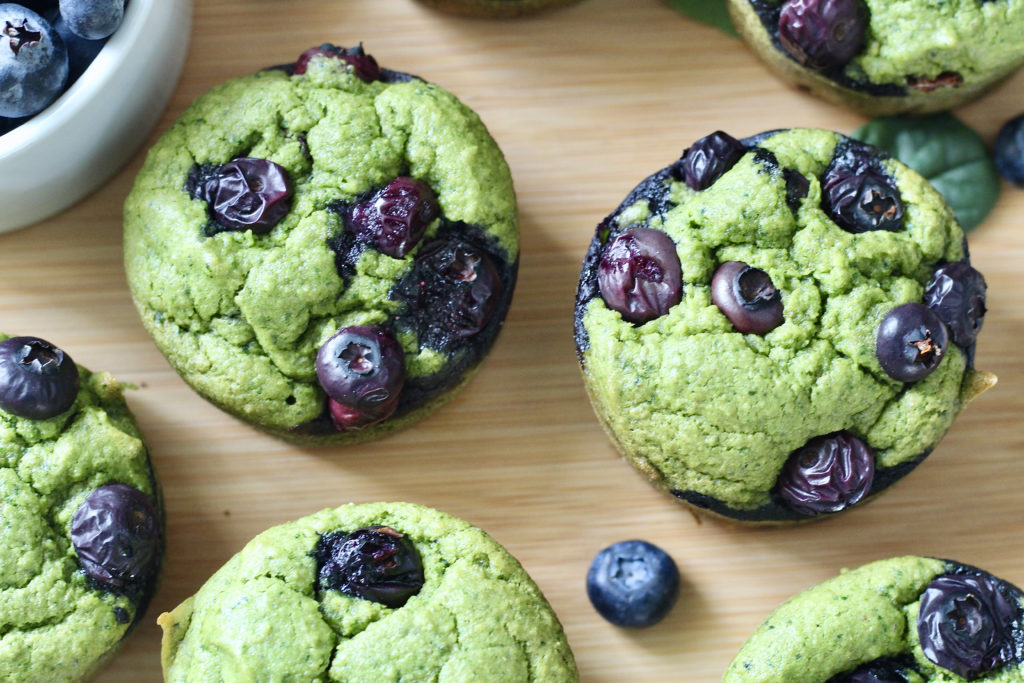 close up of spinach blender muffins with blueberries