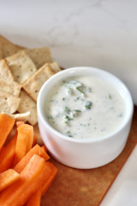 dijon aioli with carrot sticks in white ramekin