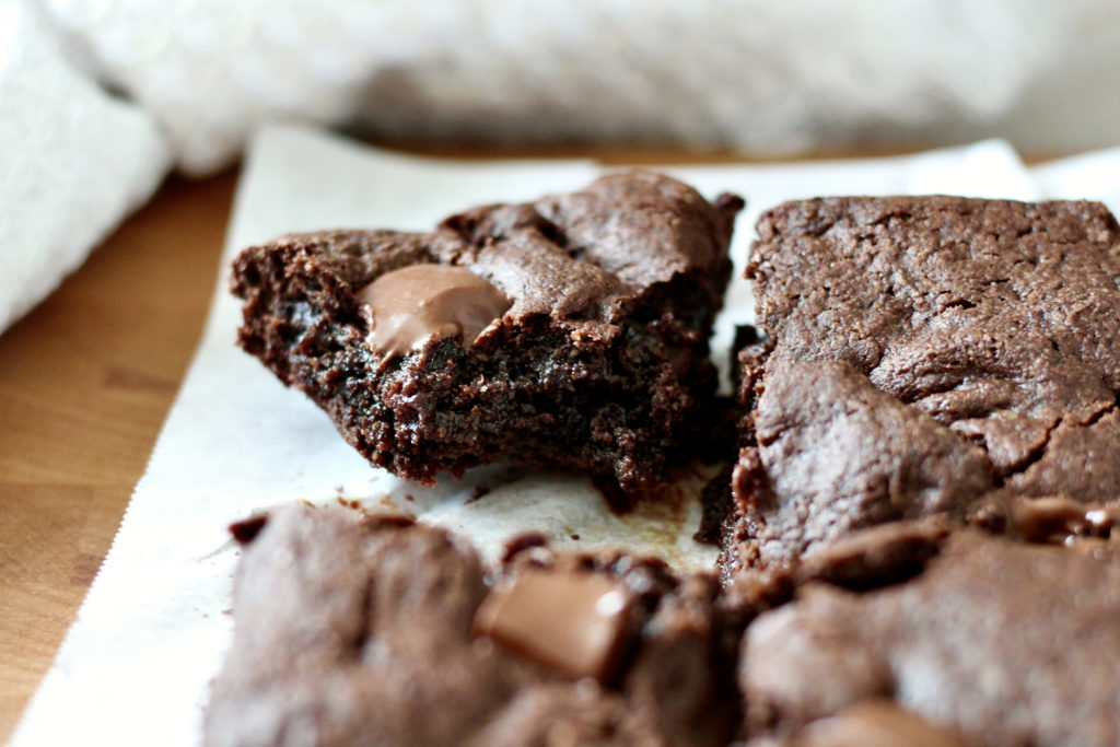 slice of gluten free brownies on white parchment paper