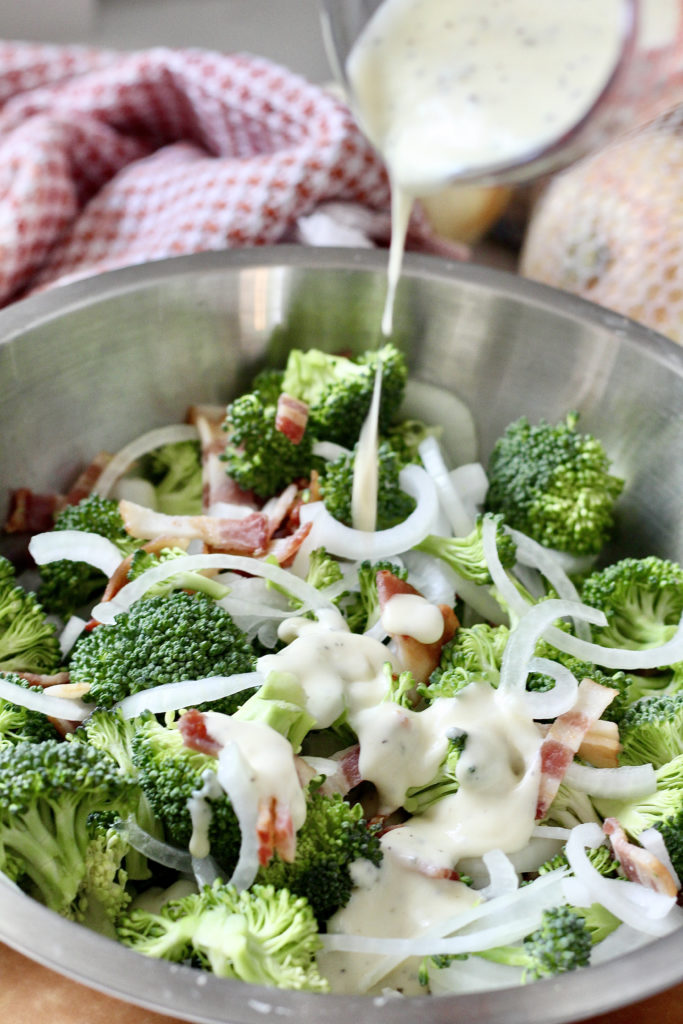 pouring ranch dressing on low carb broccoli salad
