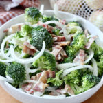 low carb broccoli salad with vidalia onions in white bowl
