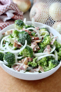 low carb broccoli salad with vidalia onions in white bowl